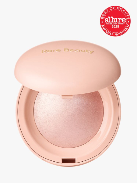 Rare Beauty Positive Light Silky Touch Highlighter in branded peach compact on light gray background with red Allure Best of Beauty seal in the top right corner